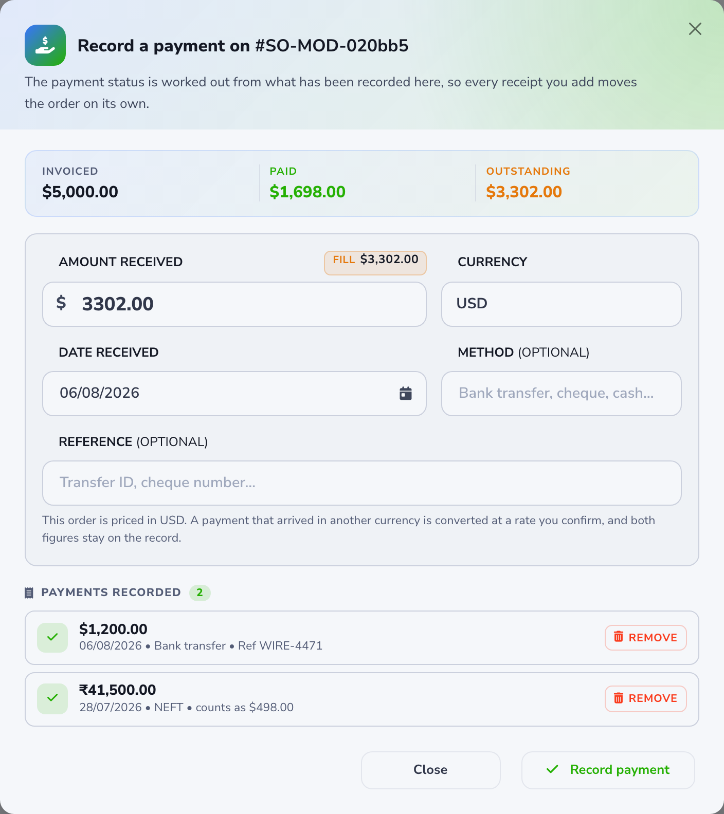 Record a payment modal on a sales order, showing invoiced, paid, and outstanding totals, the amount received form, and two recorded payments including one in rupees.